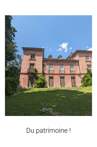 a large pink building with a sky background