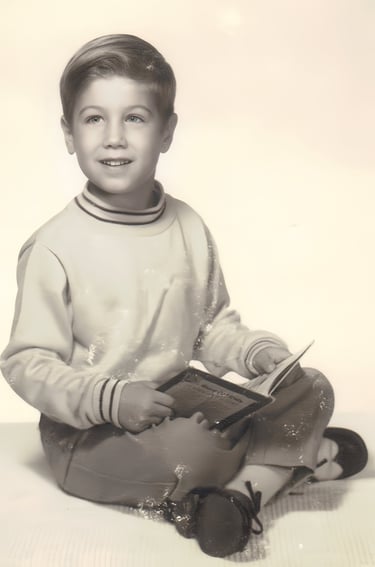 Brett Beoubay modeling children's clothing, specifically slacks, a sweater, and spectator wing tips