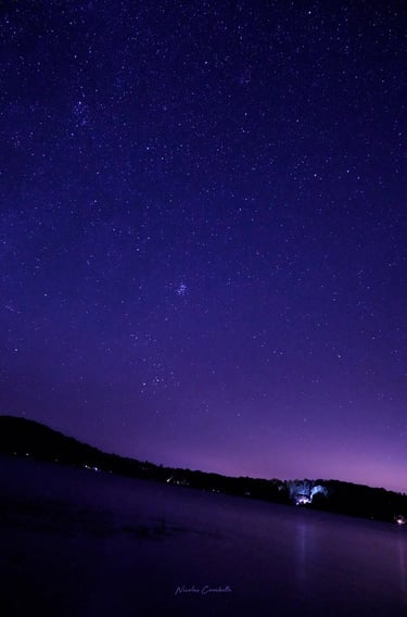 a boat is floating in the water at night