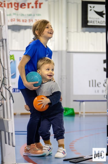 a woman and a young child playing with a ball