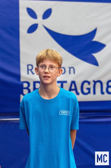 a young boy in a blue shirt and glasses