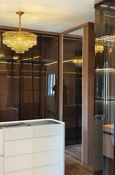Custom walk-in closet with smoked glass doors, integrated LED shelf lighting, and a minimalist white