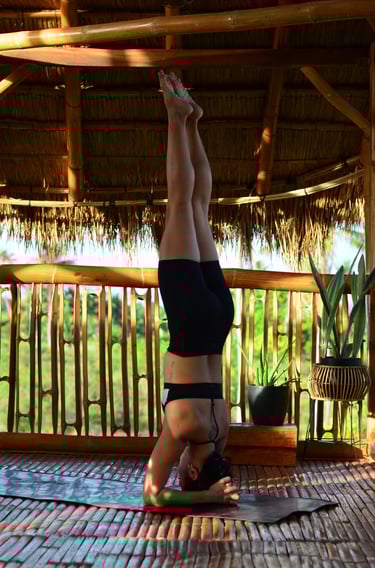 a woman doing a headstand yoga pose