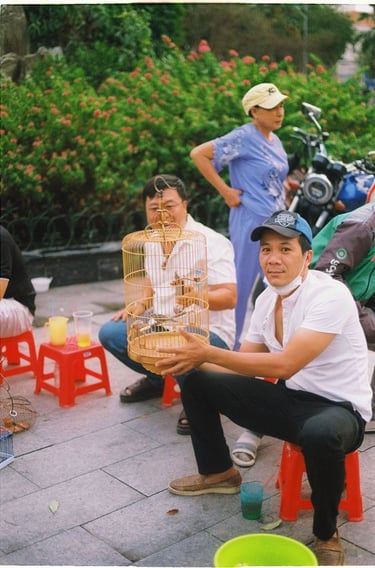 Three Vietnamese man on the bird market in Saigon China town