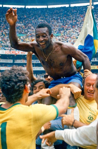 a man pelé world cup 1970 chapion is holding a man's hand while he is holding a flag