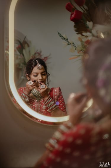 Gujarati bride getting ready in red bridal lehenga with HD bridal makeup and jewellery in Vadodara