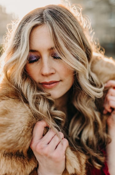 woman with 70s style makeup, and long blonde curled hair