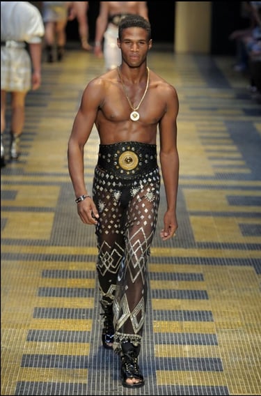 Male model on runway for donatella versace 2019 wearing Black assuit pants