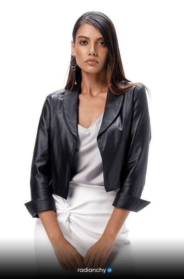 a woman in a white dress and black jacket