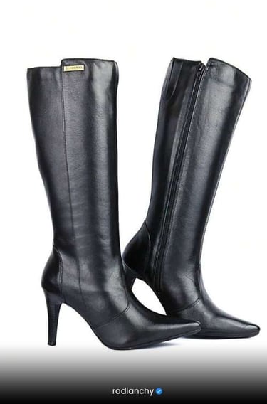 a pair of black leather boots with a high heel
