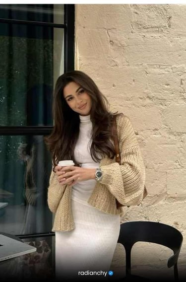 a woman in a white dress and a laptop