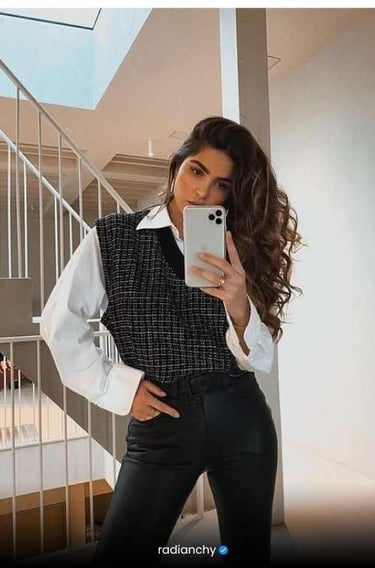a woman in a black vest and white shirt