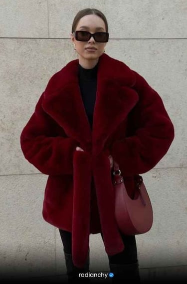 a woman in a red coat and sunglasses