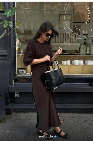 a woman in a brown dress and sunglasses