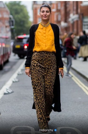 a woman in a yellow blouse and leopard print pants
