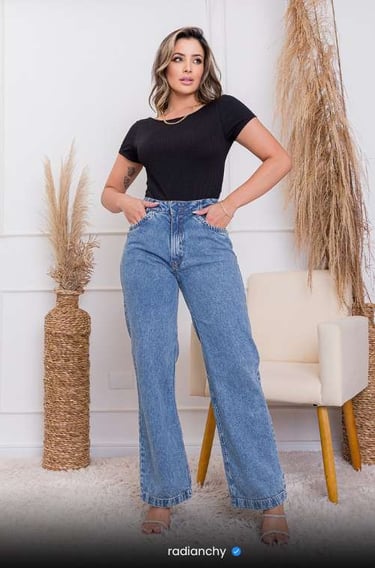 a woman in a black top and jeans jeans