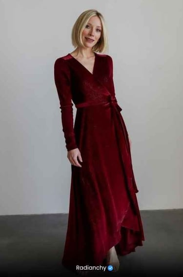 a woman in a red dress with a long sleeved dress