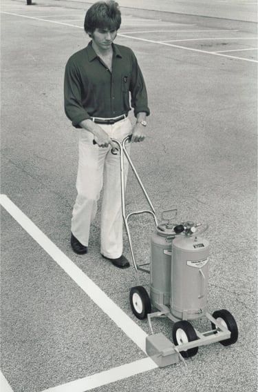 striping a parking lot using a trueline paint spraying machine