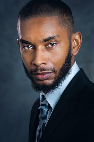 a man with a beard and a tie on a suit