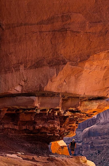 person hiking on a rock formation in the desert near Moab