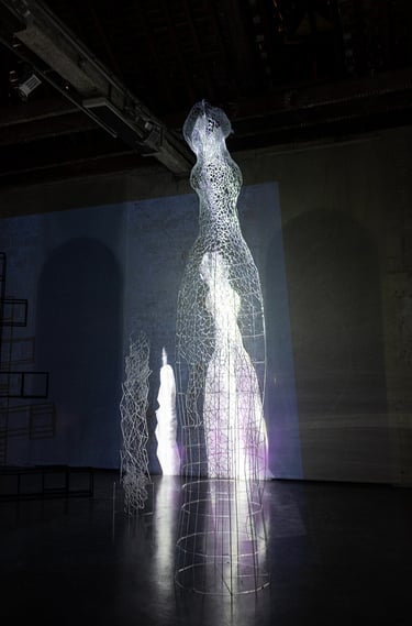 Video mapping on a large glass sculpture representing an human form