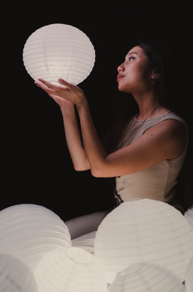 Self portrait of me holding a glowing lantern in the dark.