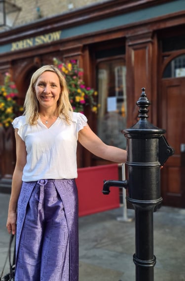 Dr Helena Seth-Smith standing at the John Snow water pump, London