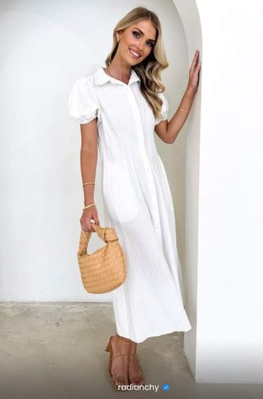 a woman in a white dress and straw hat
