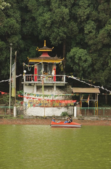 a boat on Lampokhari with a temple in the background