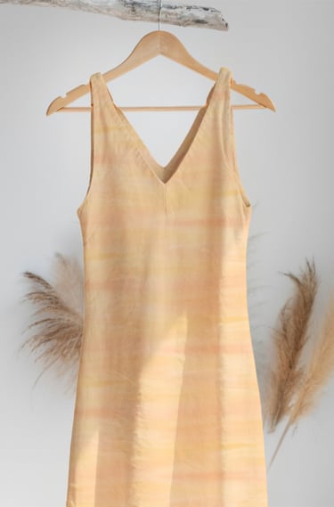 a dress hanging on a hanger in a room with the Sunshine DesignsbyKLM pattern