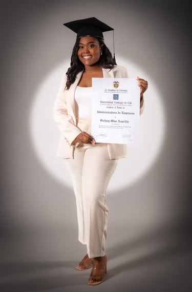 a woman in a white suit and a graduation cap