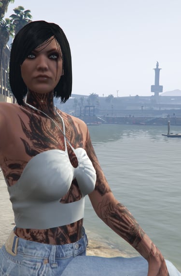 a woman with tattoos on her chest and chest