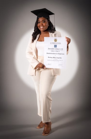 a woman in a white suit and a graduation cap