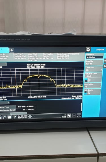 A Keysight MXA signal analyzer displaying a frequency spectrum graph and channel power data on its digital screen.