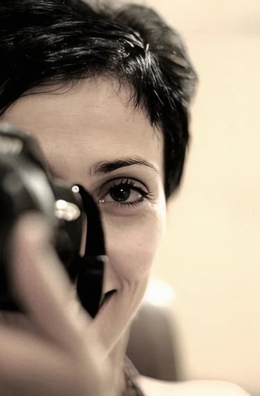 a woman with short hair taking a picture WITH A CAMERA in her hand