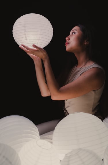 Self portrait of me holding a glowing lantern in the dark.