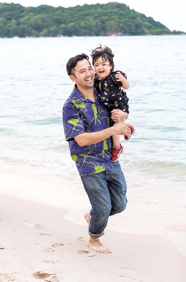 Father carrying daughter on Khem Beach in Phu Quoc