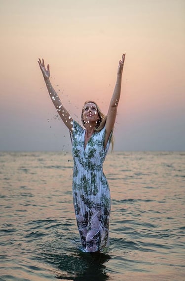 Woman splashing water during a sunset photoshoot in Phu Quoc