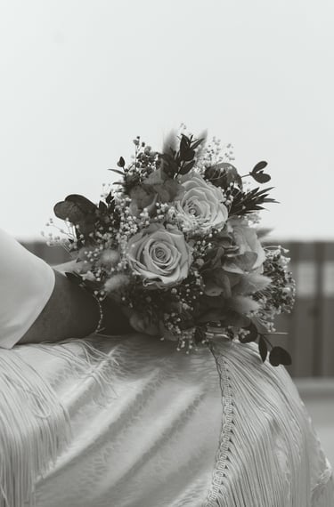 a bridesmael holding a bouquet of flowers