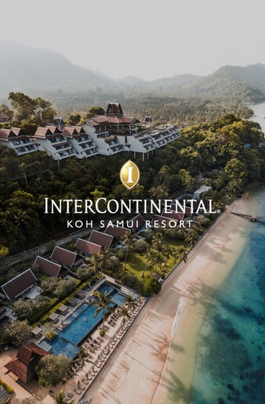 a hotel on a beach and hillside with views of the ocean