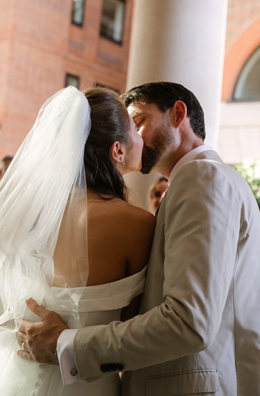 couple kissing outside of a surrey venue 