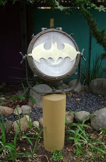 Outdoor search light with brass bat signal on the lens.