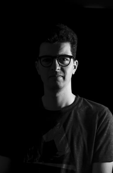 a man in glasses and a black shirt