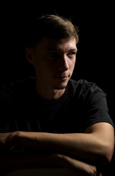 a man in a black shirt is holding a cell phone