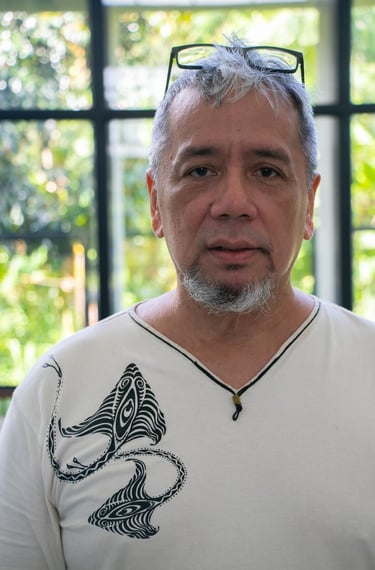 a man with a beard and glasses on a white shirt