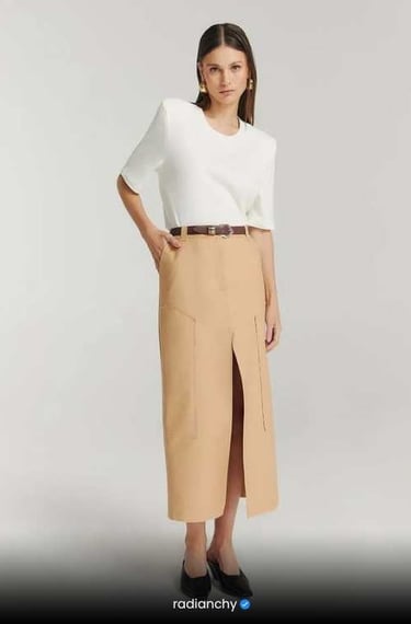 a woman in a white shirt and skirt with a skirt