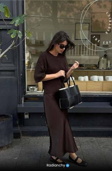 a woman in a brown dress and sunglasses
