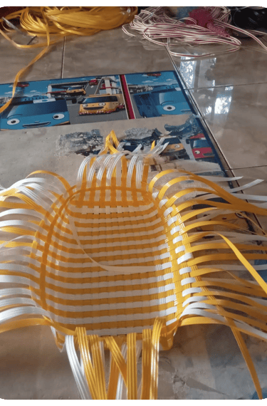 Base structure of a handmade woven bag using natural colored recycled plastic strips at Craftvitas Indonesia.
