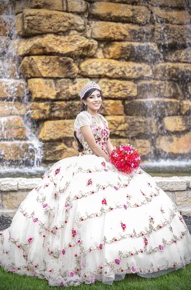 a woman in a white quinceanera dress with a bouquet of flowers