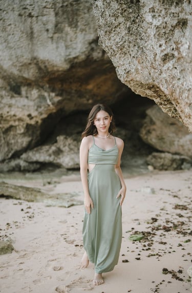 Portrait of woman standing near cave rock formation at Geger Beach Nusa Dua Bali